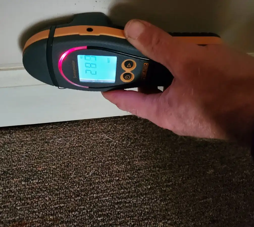 Moisture detection at baseboard during Storm Damage Restoration in Raton
